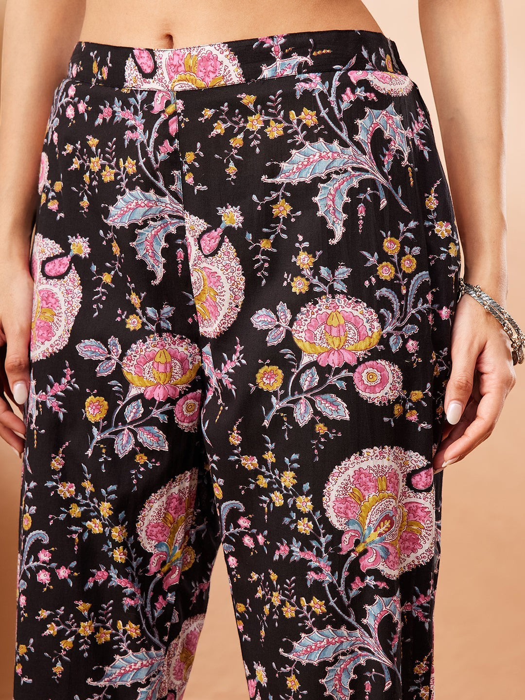 Naanu black A-line kurta and slim-fit pants set with multicolour floral and paisley print. Features embroidered square neckline and 3/4 sleeves.