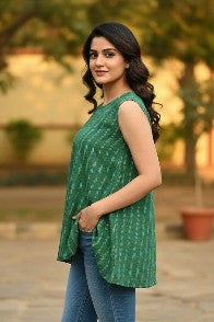 Naanu emerald green cotton ikat sleeveless boxy top with white and golden yellow diagonal dash stripes and curved hem.