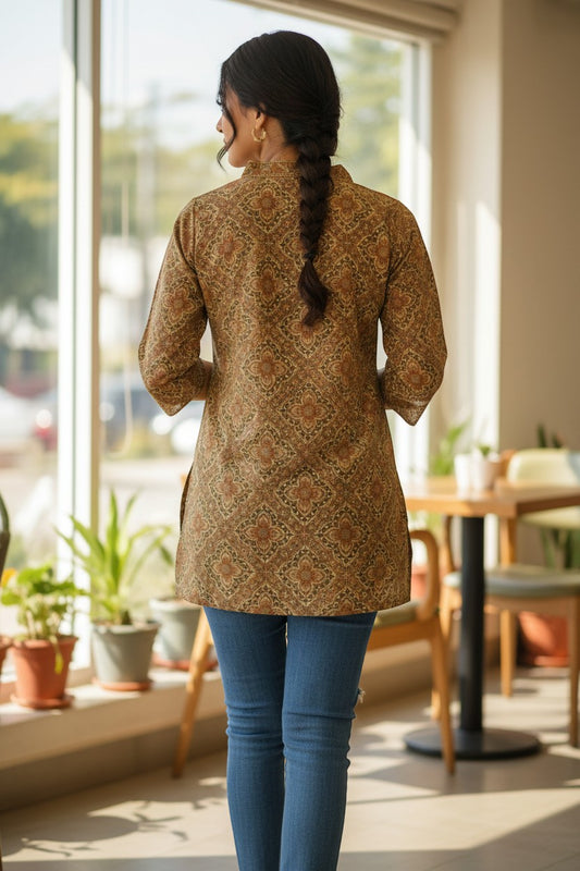 Naanu golden camel beige cotton kurti with dark brown & olive green Ajrakh geometric print, 3/4 sleeves, and gold zari V-neck.