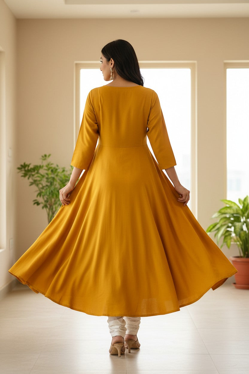 Naanu mustard yellow A-line kurta with 3/4 sleeves and a burgundy floral center panel. Model wears white churidar.