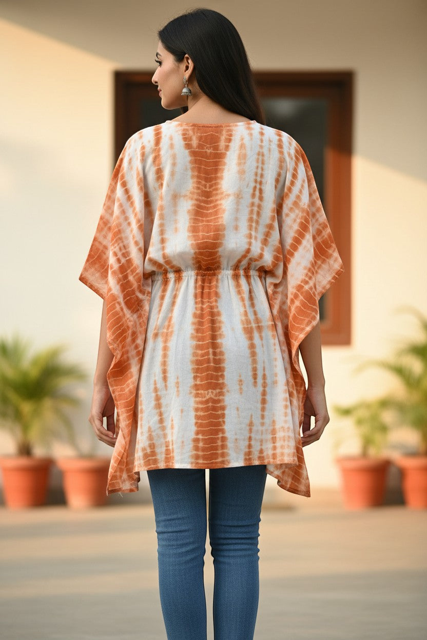 Naanu white and burnt orange shibori tie-dye cotton kaftan top with batwing sleeves and smocked waist.