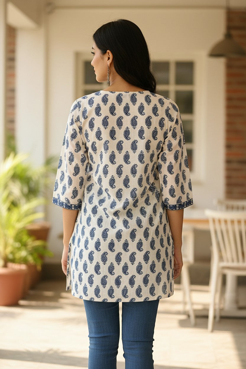 Naanu white cotton kurti with navy blue Sanganeri paisley print, 3/4 sleeves, and straight hem.