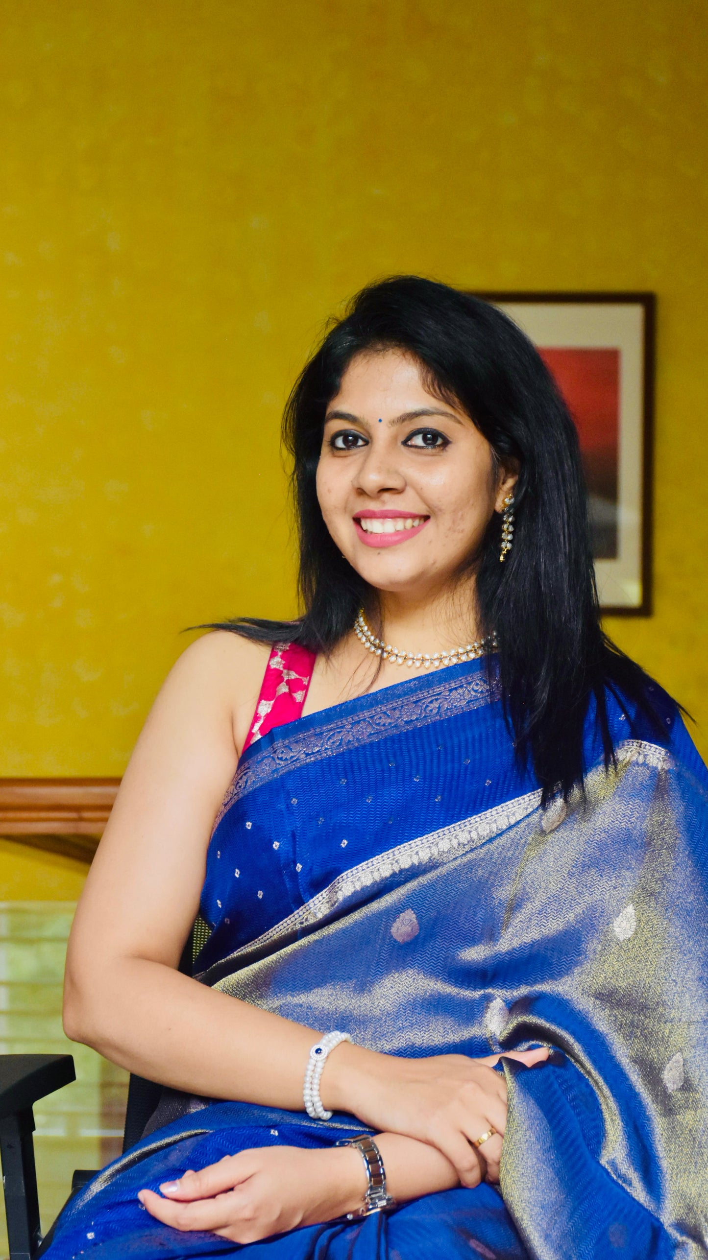 Royal blue Banarasi silk saree - model seated showing full drape spread