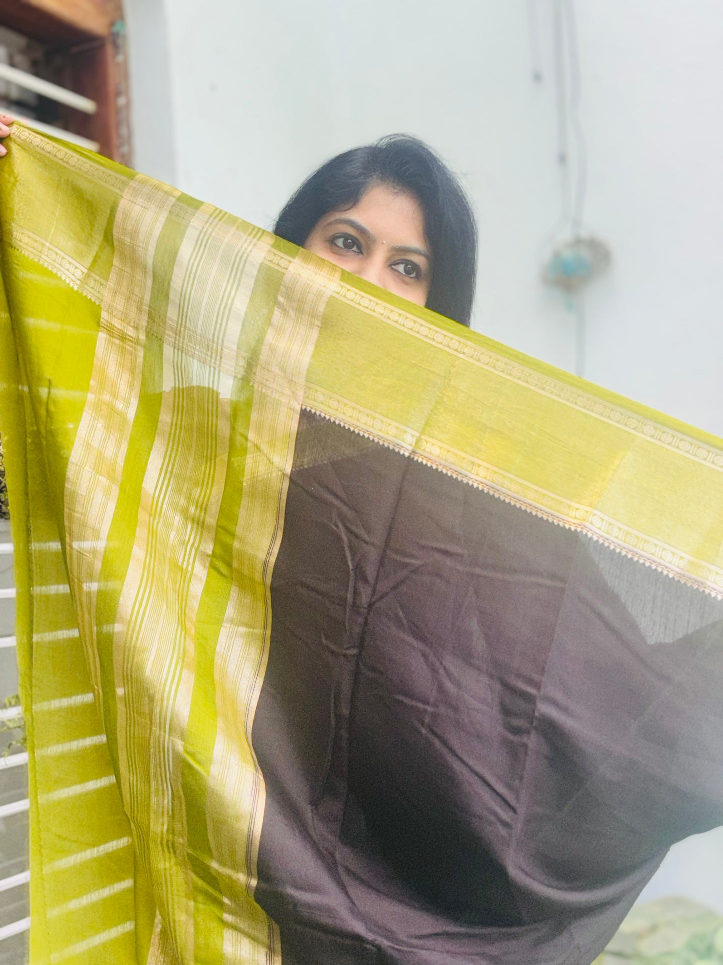 Black and green Assam silk saree - fabric close-up with zari border detail