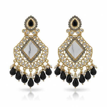 Naanu antique gold chandbali earrings with white marble center, black teardrop crystals, and pearl accents.