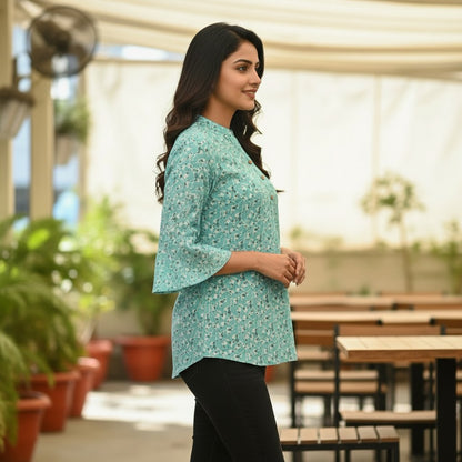 Naanu aqua mint short tunic top with a scattered dark teal floral sprig print, V-neck, 3-button placket, and 3/4 bell sleeves.