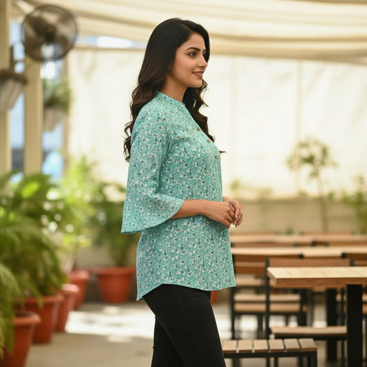 Naanu aqua mint short tunic top with a scattered dark teal floral sprig print, V-neck, 3-button placket, and 3/4 bell sleeves.