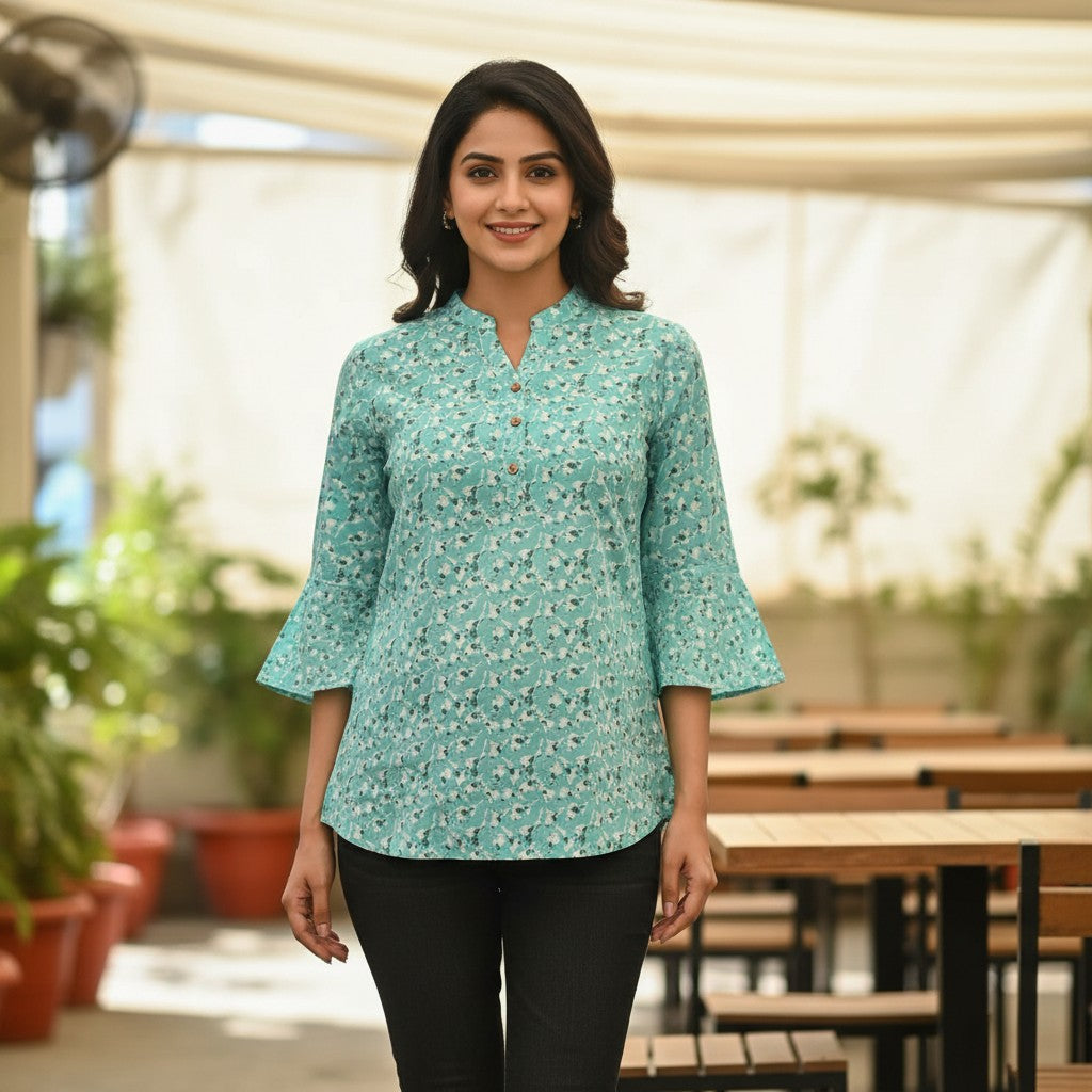 Naanu aqua mint short tunic top with a scattered dark teal floral sprig print, V-neck, 3/4 sleeves, and button placket.