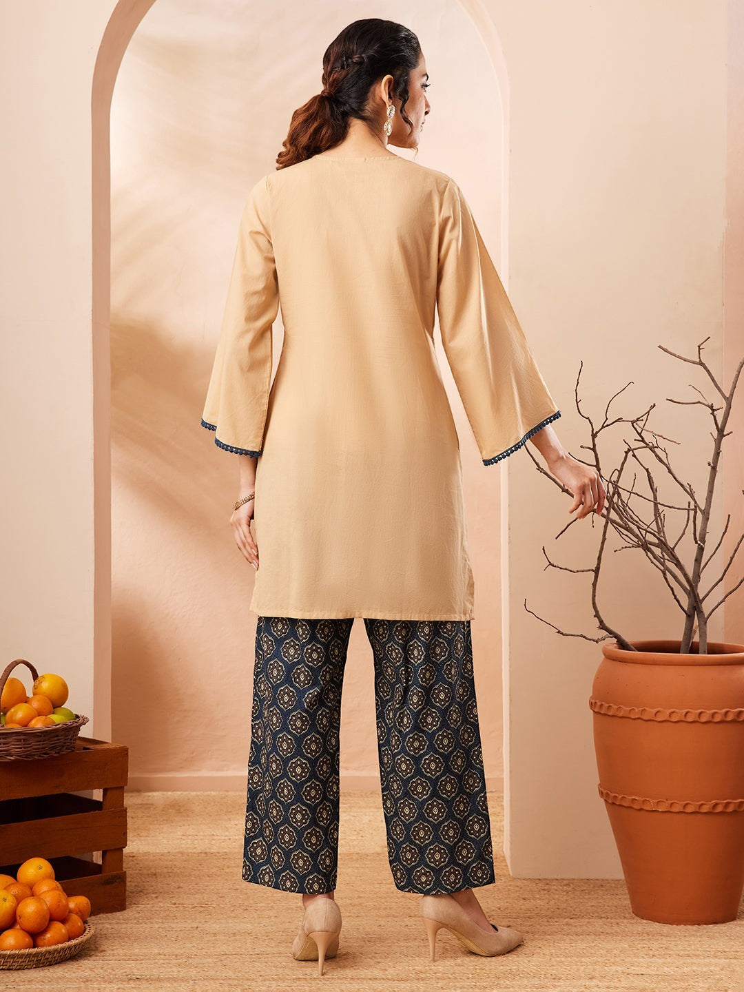 Naanu beige cotton co-ord set with embroidered V-neck top and navy Ajrakh print palazzo pants.