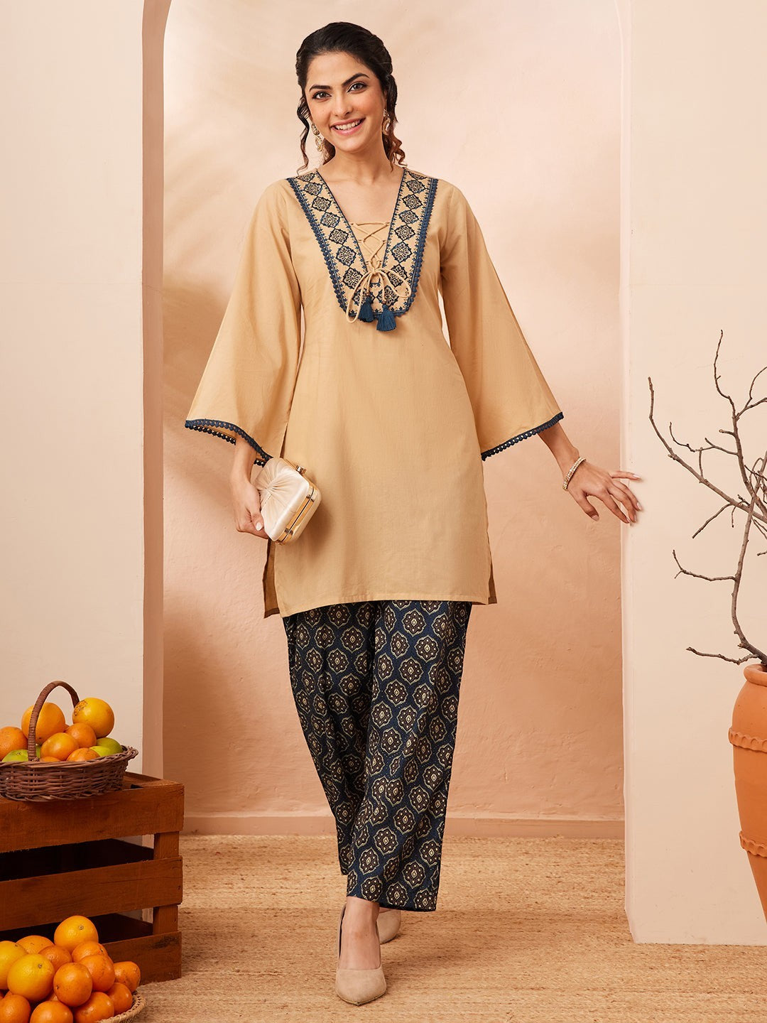 Naanu beige cotton co-ord set with navy Ajrakh print palazzo pants, featuring embroidered V-neck and bell sleeves.