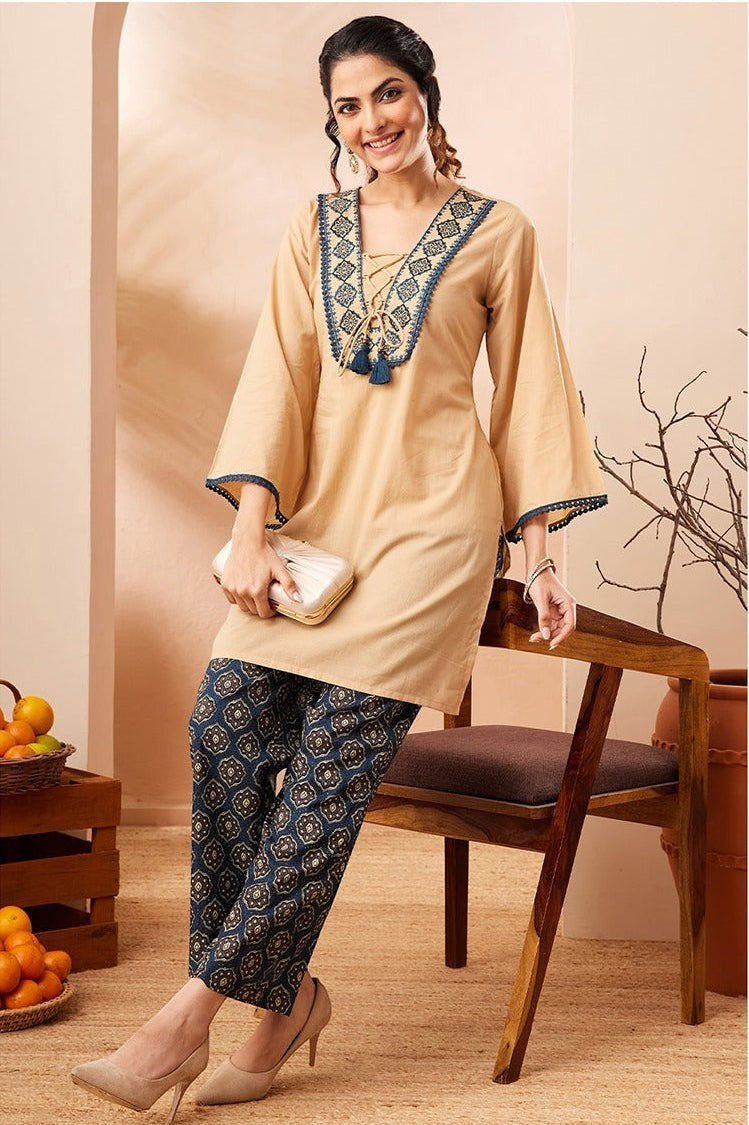 Naanu beige cotton co-ord set with embroidered V-neck and navy Ajrakh print palazzo pants.