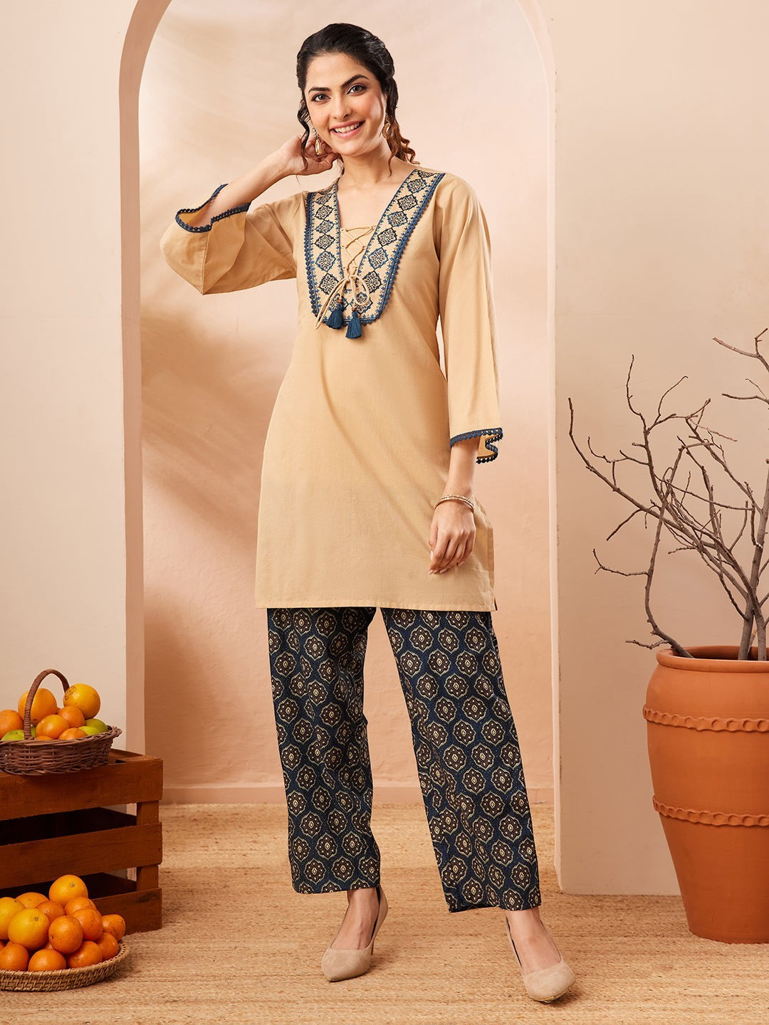Naanu beige cotton co-ord set with embroidered V-neck and navy Ajrakh print palazzo pants.