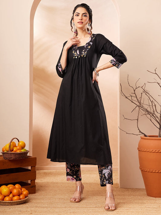 Naanu black A-line kurta with embroidered square neckline and floral print slim pants. 3/4 sleeves with embroidered cuffs.