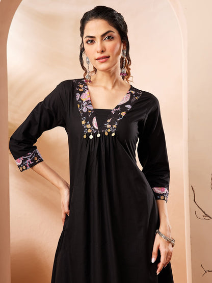 Naanu black A-line kurta with embroidered square neckline and floral print cuffs, paired with slim floral print pants.
