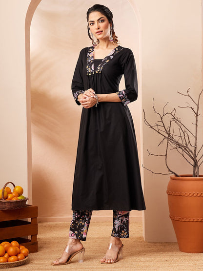 Naanu black A-line kurta with embroidered square neckline and floral print slim pants. 3/4 sleeves with embroidered cuffs.
