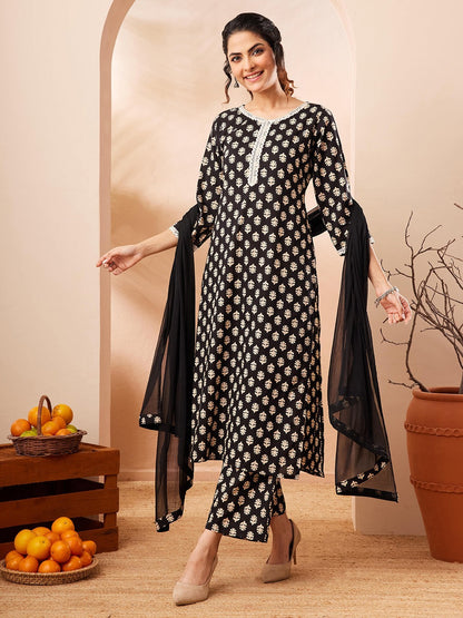 Naanu black rayon kurta set with gold leaf print, white lace trim, straight pants, and sheer dupatta.