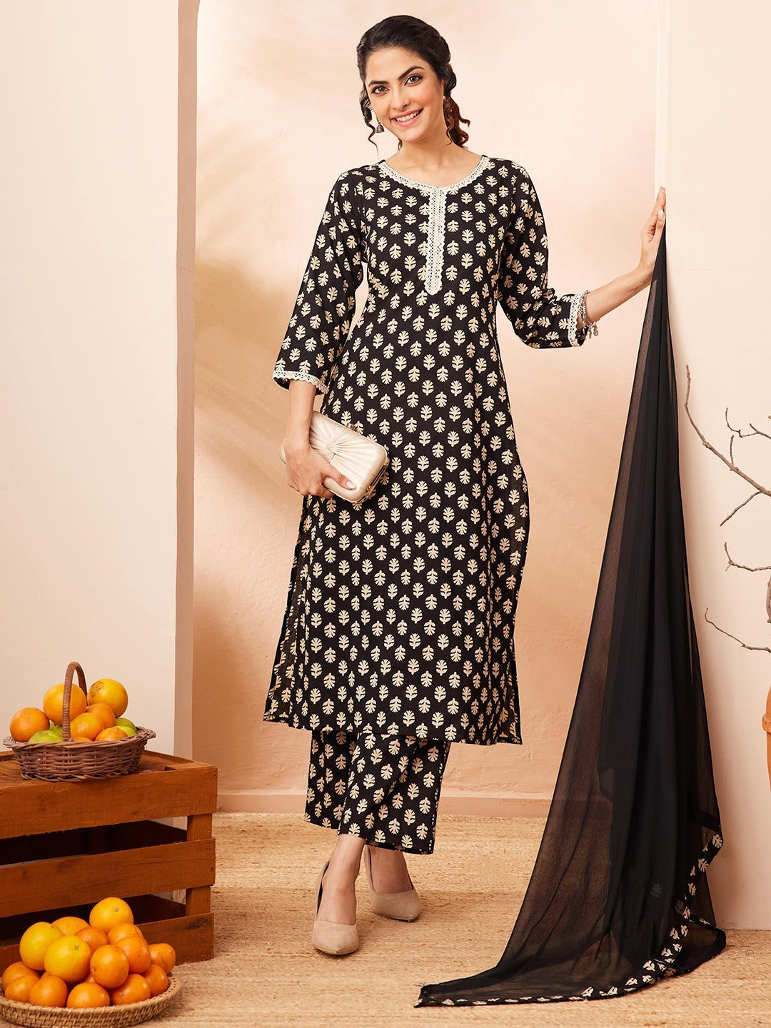 Naanu black rayon kurta set with gold leaf butti print, white lace trim, 3/4 sleeves, straight pants, and black chiffon dupatta.