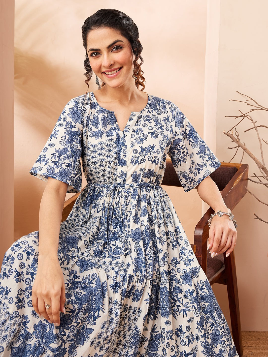 Naanu blue and white floral patchwork tiered midi dress with flutter sleeves and a notched V-neckline.
