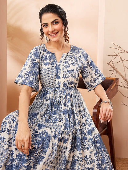 Naanu blue and white floral patchwork tiered midi dress with flutter sleeves and a notched V-neckline.