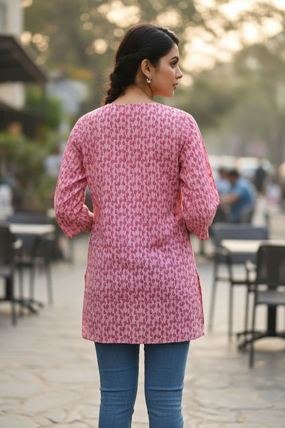 Naanu blush pink cotton short kurti with all-over paisley buta print, 3/4 sleeves, and side pockets.