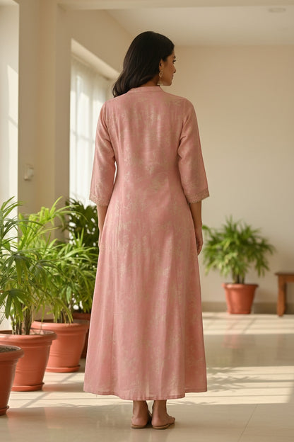 Naanu blush pink and rose gold A-line kurta with woven floral booti, gold buttons, and gold sleeve trim.