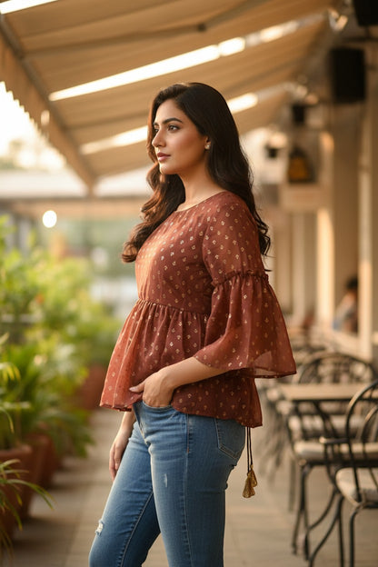 Naanu brick brown sheer georgette peplum top with gold tulip butti, bell sleeves, and tassel tie.