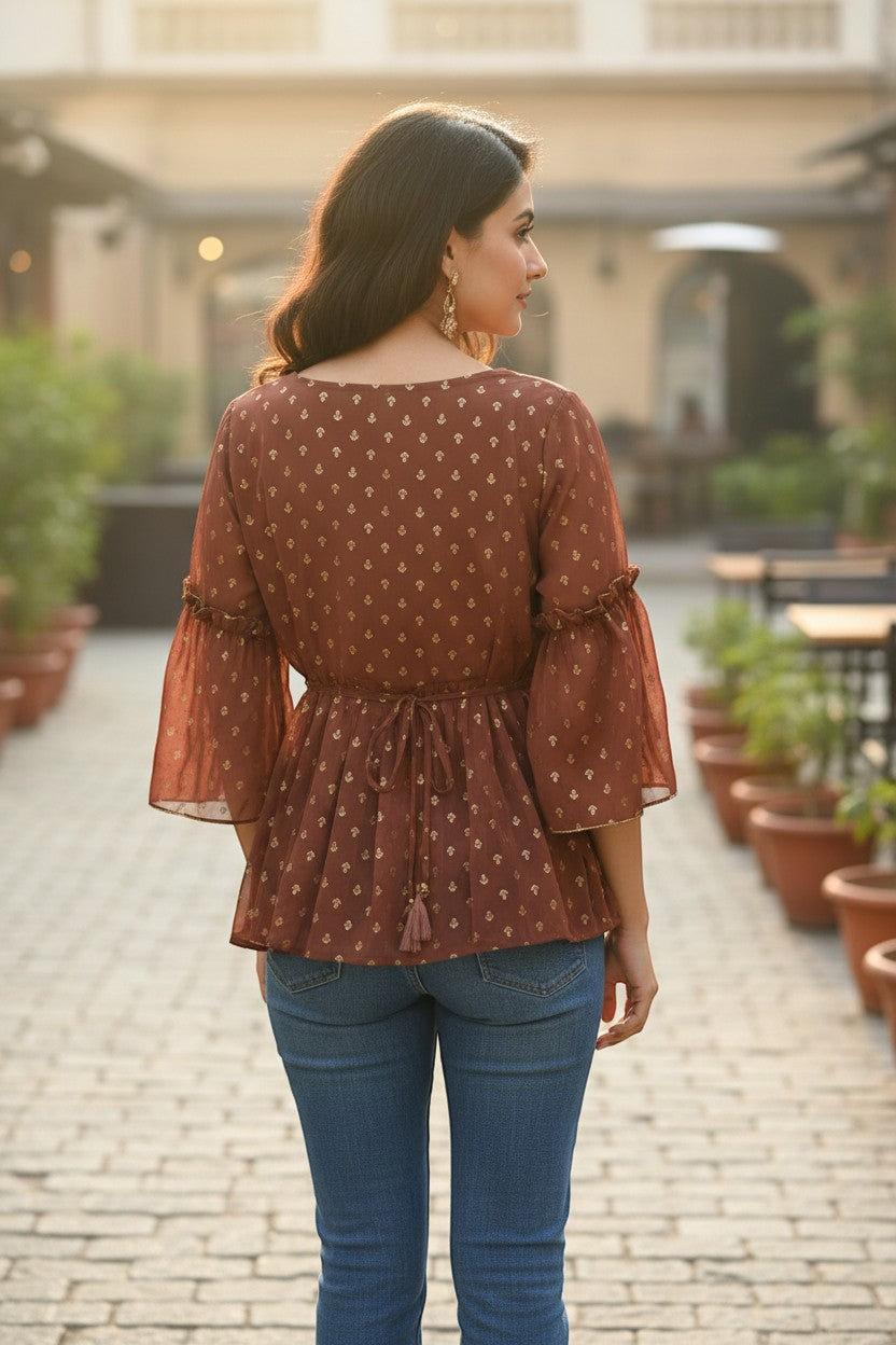 Naanu brick brown sheer georgette peplum top with gold tulip butti print, bell sleeves, and tassel tie-back.