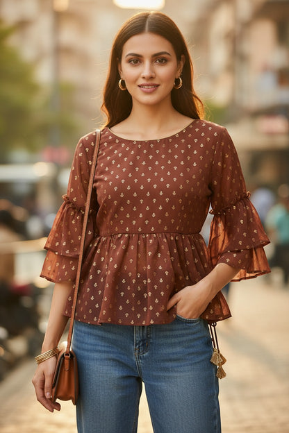 Naanu brick brown georgette peplum top with gold tulip butti print, scoop neck, and double ruffle bell sleeves.