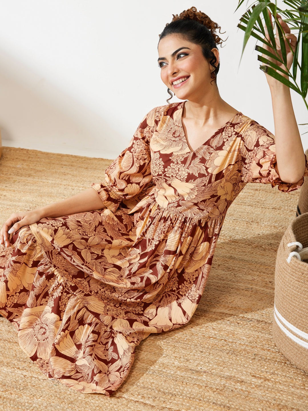 Naanu brown floral midi dress with V-neck, puff sleeves, and tiered skirt. Boho chic ethnic fusion wear.