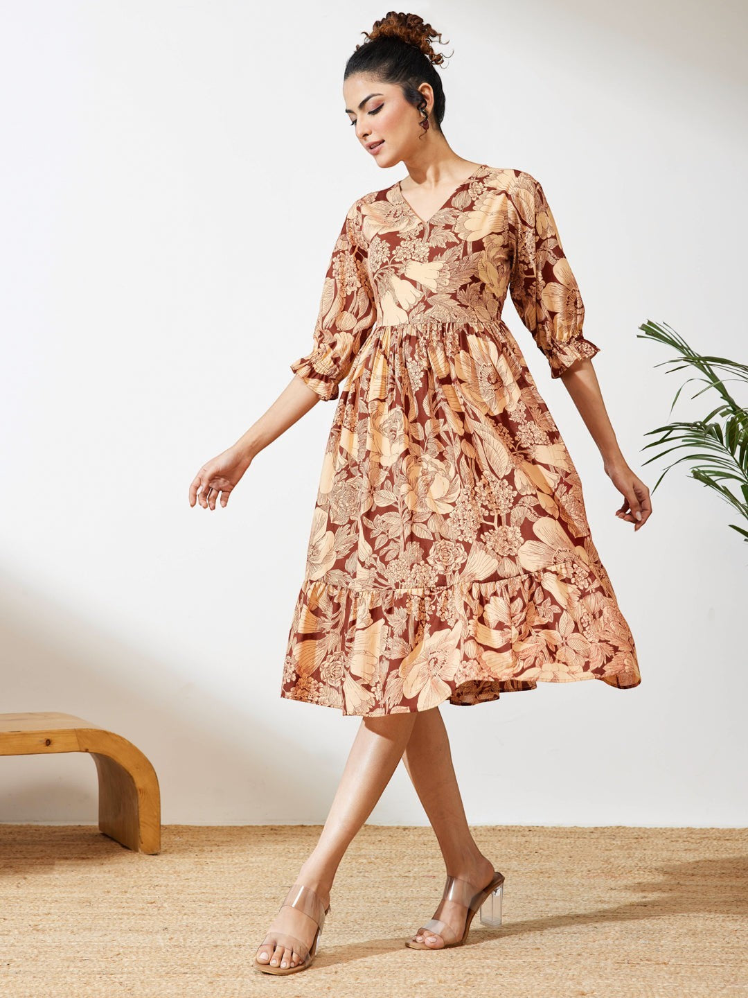 Naanu brown floral midi dress with V-neck, puff sleeves, and tiered skirt. Boho chic ethnic fusion.