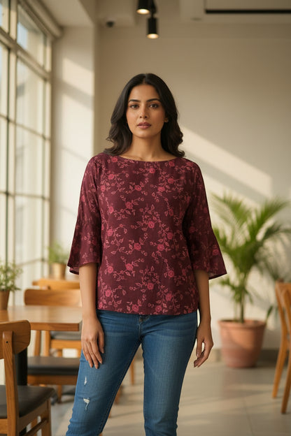 Naanu deep wine burgundy georgette top with pink rose floral vine print, boat neck, and bell sleeves.