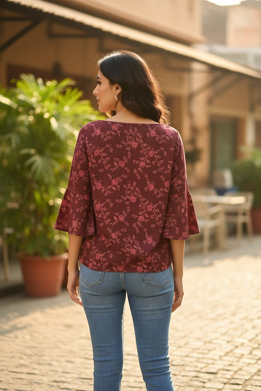 Naanu deep wine burgundy georgette top with pink rose floral vine print, boat neck, and bell sleeves.