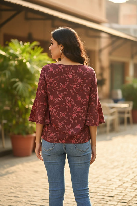 Naanu deep wine burgundy georgette top with pink rose floral vine print, boat neck, and bell sleeves.