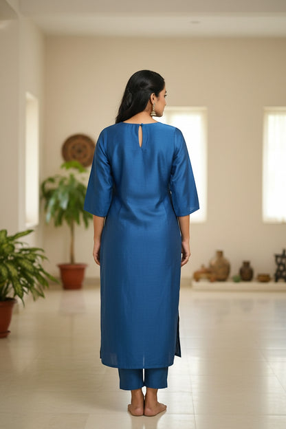 Naanu cerulean blue silk-like kurta with golden marigold floral embroidery on U-neckline yoke and elbow sleeves.