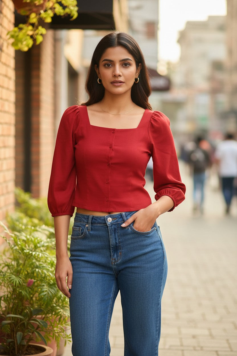 Naanu cherry red polyester short top with square neck, puff 3/4 sleeves, and button-down front, paired with blue jeans.
