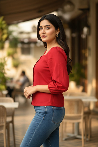 Naanu cherry red polyester short top with square neck, puff 3/4 sleeves, and button-down front, worn by a model with blue jeans.