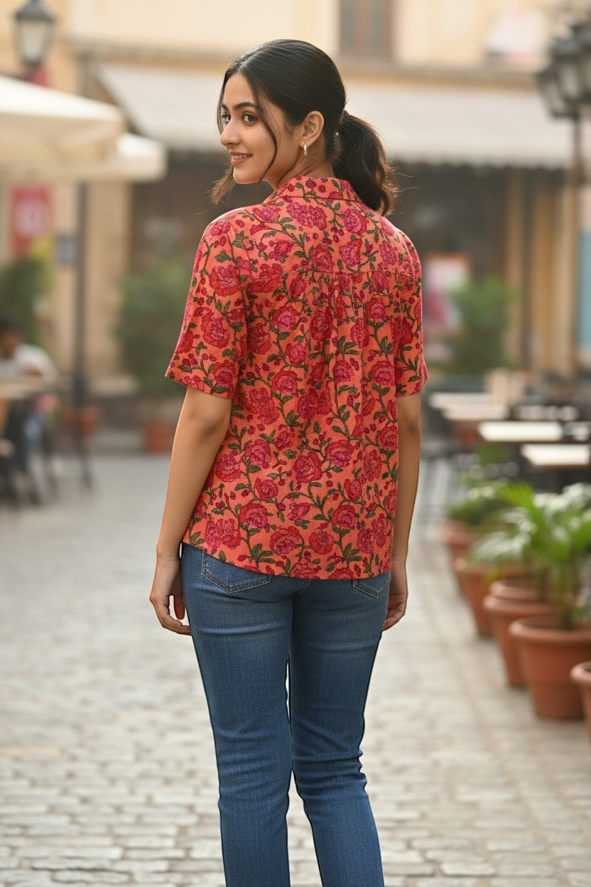 Naanu coral orange pink cotton shirt with pomegranate floral block print, V-notch neck, and short sleeves.