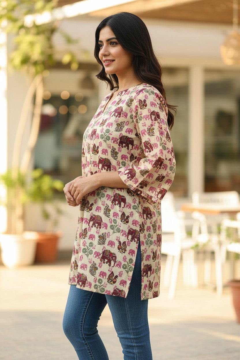 Naanu cream cotton kurti with elephant and peacock print, featuring 3/4 bell sleeves and a V-notch neckline.