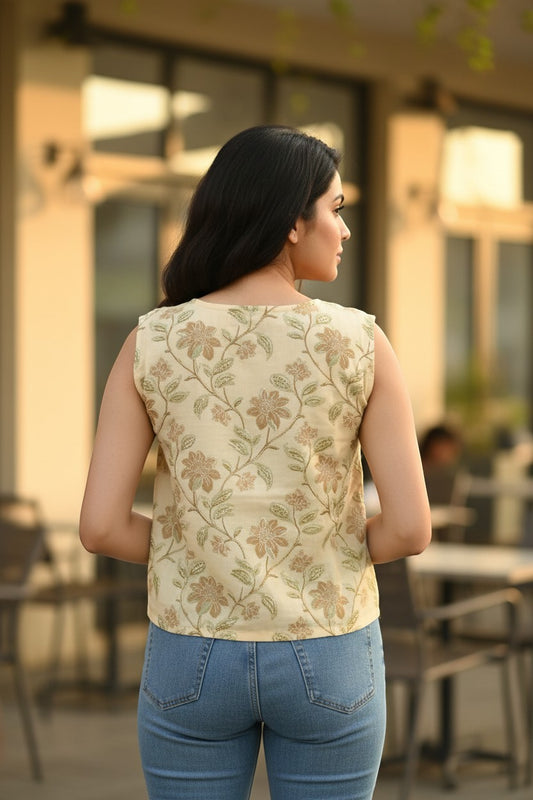 Naanu cream ivory sleeveless boxy top with golden olive floral embroidery. 100% cotton.