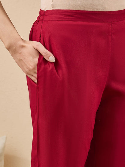 Naanu crimson red straight kurta set with lace trim, scalloped neckline, 3/4 sleeves, and slim pants.