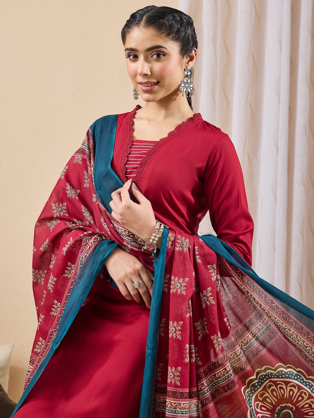 Naanu crimson red lace trim straight kurta with 3/4 sleeves, slim pants, and printed dupatta with teal border.