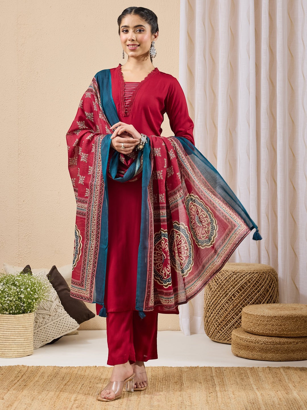 Naanu crimson red 3-piece ethnic set with lace trim straight kurta, slim pants, and printed dupatta with teal border.