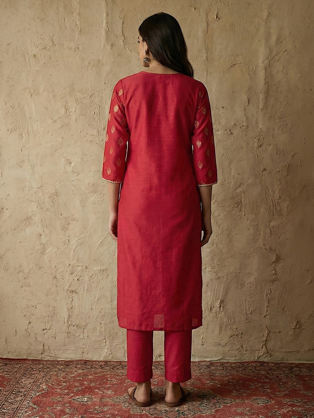 Naanu crimson silk blend straight kurta set with gold foil butti print, gold lace trim on notched V-neck and 3/4 sleeves, paired with straight pants.