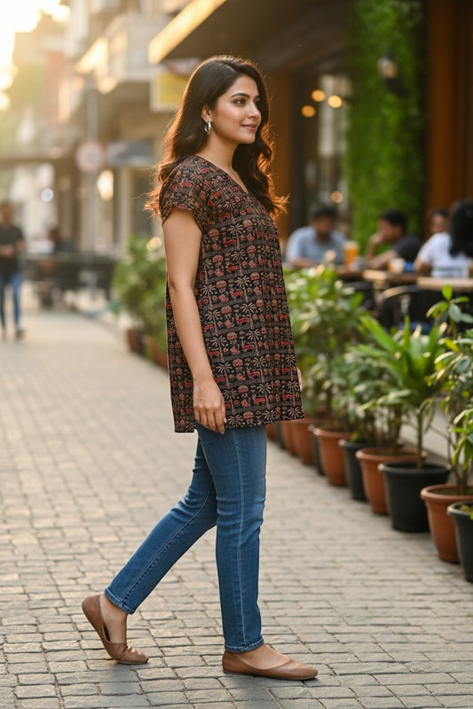 Naanu dark brown cotton top with V-neck, short sleeves, and Warli tribal print of deer and palm trees.