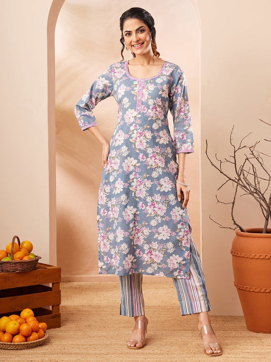 Naanu dusty blue floral print kurta with pink lace trim and matching striped pants.