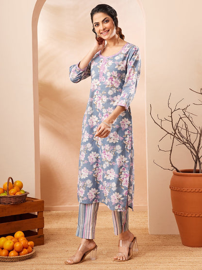 Naanu dusty blue floral print kurta with pink lace trim and 3/4 sleeves, paired with striped pants.