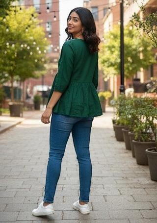 Naanu forest green cotton peplum top with white chikankari embroidery on yoke and 3/4 sleeves.