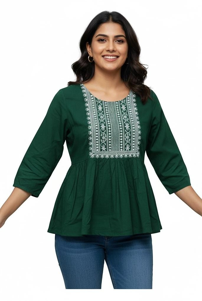 Naanu forest green cotton peplum top with white chikankari embroidery on yoke and 3/4 sleeves.