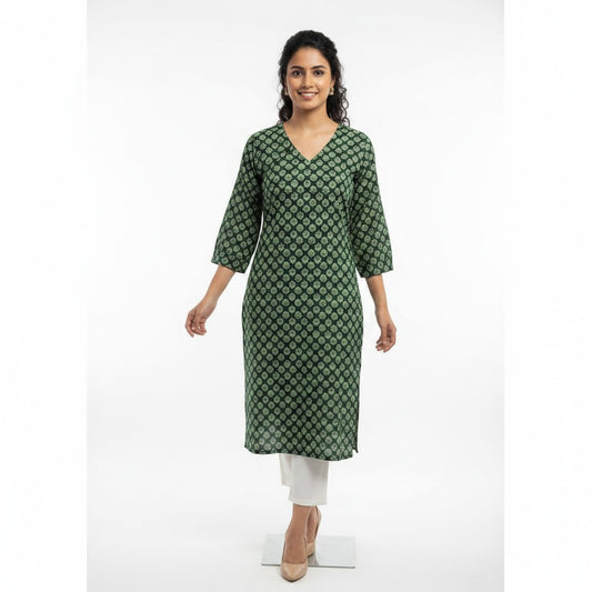 Naanu dark green cotton kurta with white floral block print, V-neck, and puffed sleeves. Model wears white pants.