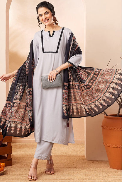 Naanu grey rayon straight kurta set with black contrast border and printed dupatta. Model wears 3/4 sleeves and straight-leg pants.
